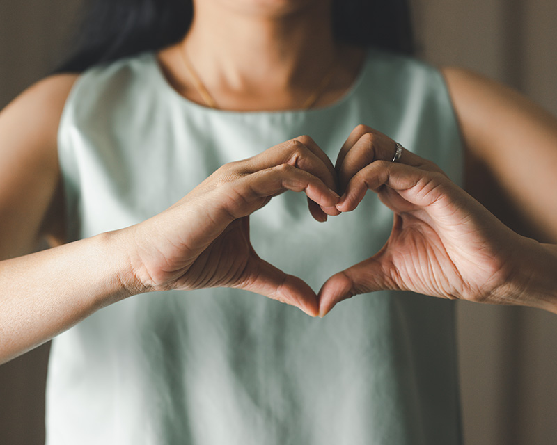 heal_from_Narcissistic_Abuse_emdr_ifs Woman making a heart with her hands after doing IFS and EMDR for Narcissistic Abuse and CPTSD